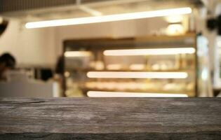 Empty dark wooden table in front of abstract blurred bokeh background of restaurant . can be used for display or montage your products.Mock up for space. photo