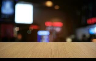 Empty dark wooden table in front of abstract blurred bokeh background of restaurant . can be used for display or montage your products.Mock up for space. photo