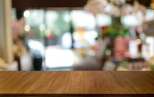 Wood table top in front of abstract blurred background. Empty wooden table space for text marketing promotion. blank wood table surface copy space photo