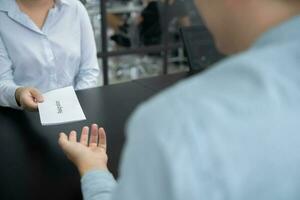 Business woman sending resignation letter to boss and Holding Stuff Resign Depress or carrying cardboard box by desk in office photo