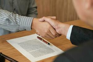 Female lawyer handshake with client. Business partnership meeting successful concept. photo