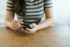 Woman texting checking social media holding smartphone at home Conversation with boyfriend or friend photo