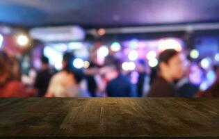 Empty dark wooden table in front of abstract blurred bokeh background of restaurant . can be used for display or montage your products.Mock up for space. photo