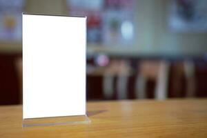 Mock up Menu frame standing on wood table in Bar restaurant cafe. space for text photo