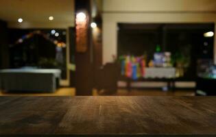 Empty dark wooden table in front of abstract blurred bokeh background of restaurant . can be used for display or montage your products.Mock up for space. photo