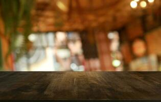 Empty wooden table in front of abstract blurred background of coffee shop . can be used for display or montage your products.Mock up for display of product photo