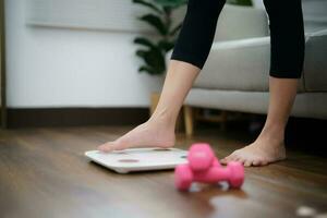 Fat diet and scale feet standing on electronic scales for weight control. Measurement instrument in kilogram for a diet control photo