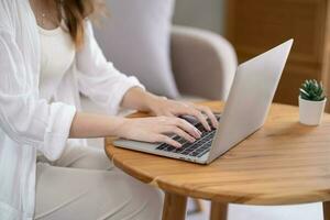 Business woman working from home. work online on laptop. Asian businesswoman working on sofa online business with social distancing laptop online meeting. photo