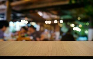 Empty dark wooden table in front of abstract blurred bokeh background of restaurant . can be used for display or montage your products.Mock up for space. photo