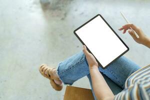 Woman holding blank screen on digital tablet device. technology background tablet with blank empty screen. photo