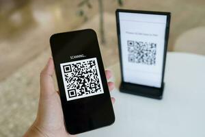 Qr code payment. E wallet. Man scanning tag accepted generate digital pay without money.scanning QR code online shopping cashless payment and verification technology concept. photo