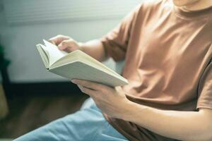 Men reading book and relaxing at home and comfort in front of opened book photo