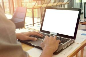 View of Details of business man hands typing on keyboard with blank screen photo