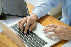 Man work from home. work online on laptop. businessman working online business concept with social distancing laptop online meeting. photo