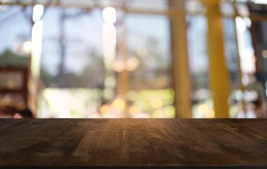 Empty dark wooden table in front of abstract blurred bokeh background of restaurant . can be used for display or montage your products.Mock up for space. photo