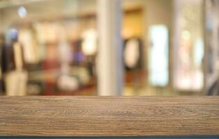 Empty wooden table in front of abstract blurred background of coffee shop . can be used for display or montage your products.Mock up for display of product photo