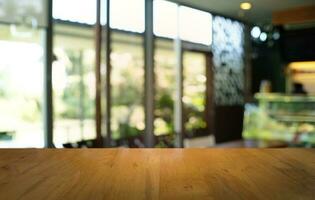 Empty dark wooden table in front of abstract blurred bokeh background of restaurant . can be used for display or montage your products.Mock up for space. photo