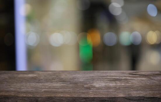 Empty wooden table in front of abstract blurred background of coffee shop . can be used for display or montage your products.Mock up for display of product photo