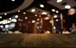 Empty dark wooden table in front of abstract blurred bokeh background of restaurant . can be used for display or montage your products.Mock up for space. photo