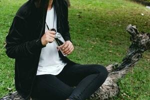 Sportswoman drinking some water from a bottle after training. photo