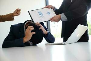 Bullying with an out of control boss shouting to a stressed employee. Anger issues and stress concept. photo