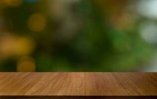 Empty wood table top and blur of out door garden background Empty wooden table space for text marketing promotion. blank wood table copy space for background photo