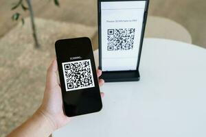 Qr code payment. E wallet. Man scanning tag accepted generate digital pay without money.scanning QR code online shopping cashless payment and verification technology concept. photo