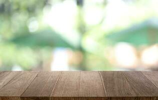 Empty wooden table in front of abstract blurred background of coffee shop . can be used for display or montage your products.Mock up for display of product photo