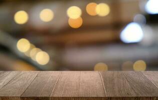 Empty dark wooden table in front of abstract blurred bokeh background of restaurant . can be used for display or montage your products.Mock up for space. photo