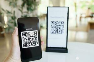 Qr code payment. E wallet. Man scanning tag accepted generate digital pay without money.scanning QR code online shopping cashless payment and verification technology concept. photo