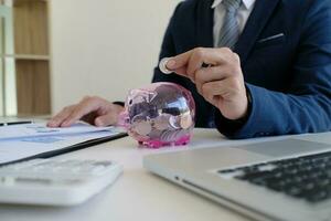 Accountant verify the business and saving money stacking gold coins with calculator. Accountancy Concept photo