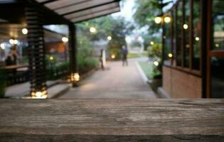 Empty dark wooden table in front of abstract blurred bokeh background of restaurant . can be used for display or montage your products.Mock up for space. photo