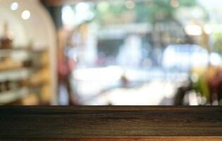 Empty wooden table in front of abstract blurred background of coffee shop . can be used for display or montage your products.Mock up for display of product photo