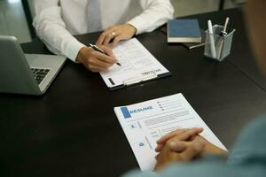 Examiner reading a resume during job interview at office Business and human resources concept. photo