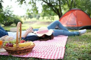 Happy couple lying camping on the nature park, in love concept. photo