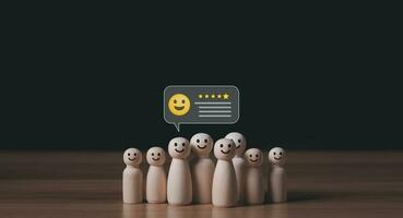 Customer service And satisfaction survey results give a 5-star rating and a smiley face. Customer feedback is very good.Wooden doll with icons showing emotions and scores. photo