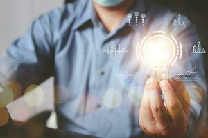 Businessman Hand holding Light bulb Global Internet connection. Business global internet connection application technology and digital marketing, Financial and banking, Digital link tech, big data. photo