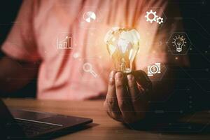 Businessman Hand holding Light bulb Global Internet connection. Business global internet connection application technology and digital marketing, Financial and banking, Digital link tech, big data. photo