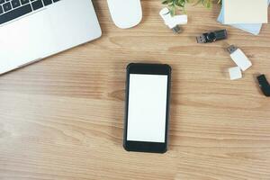 Top view of designer workplace with mock up smartphone on table. photo