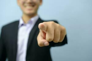 Close up ortrait of businessman pointing at camera. photo