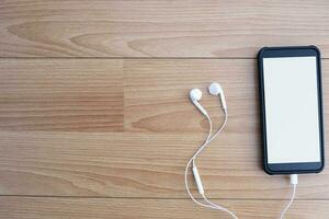 Top view of designer workplace with mock up smartphone on table. photo