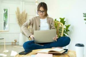 Young collage student using computer and mobile device studying online. photo