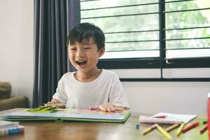 Happy boy when reding a picture book at home. photo