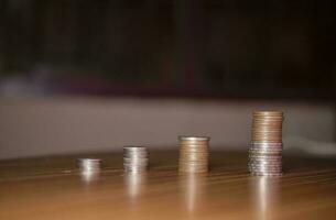 Stacking coins on the wooden table and growth graph to save money or investment to get business income by finance  marketing photo