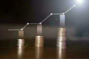 Stacking coins on the wooden table and growth graph line chart target to save money or investment of business concept income by finance  marketing photo