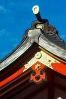 Japanese temple roof with blue sky in the background photo