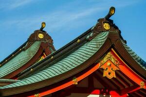 Japanese temple roof with blue sky in the background photo