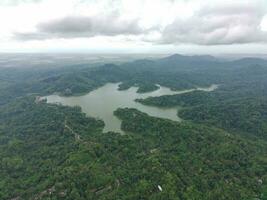 Aerial view of the reservoir between the mountains and forest. photo