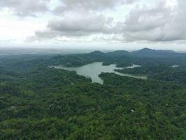 Aerial view of the reservoir between the mountains and forest. photo