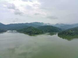 Aerial view of the reservoir between the mountains and forest. photo